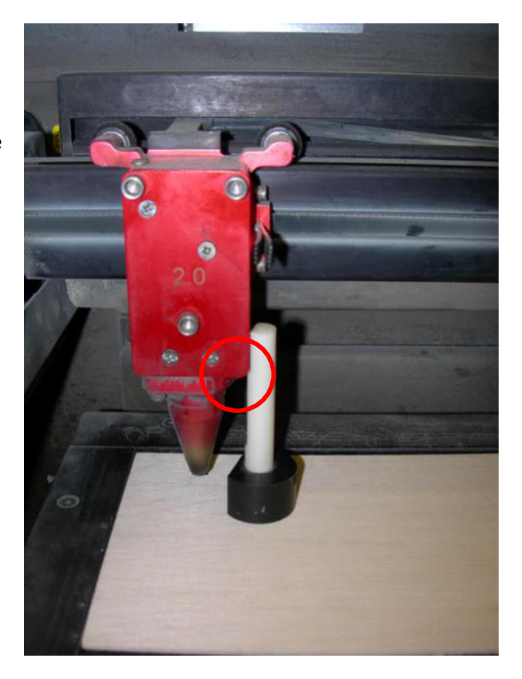Focus tool resting on the material with its notch against the side of the laser focus carriage
