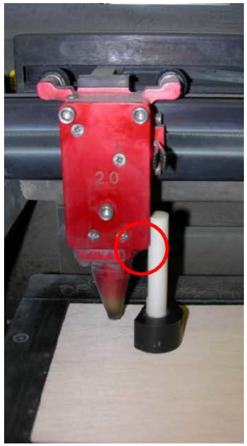 Focus tool resting on the material with its notch against the side of the red laser focus carriage